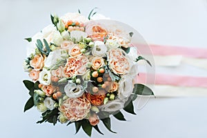 Beautiful wedding bouquet decorated with white and pink roses, bridal flowers of pastel colour