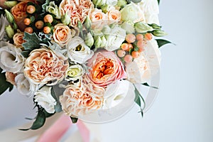 Beautiful wedding bouquet decorated with white and pink roses, bridal flowers of pastel colour