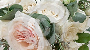 Beautiful wedding bouquet of delicate white pink cream roses. Silk petals and lush greens. A gift for the holiday