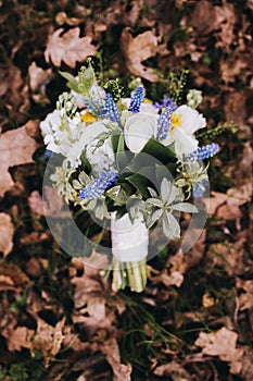 Beautiful wedding bouquet of different white, blue, green flower