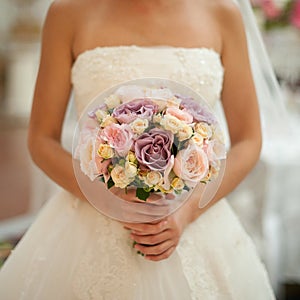 Beautiful wedding bouquet in hands of the bride