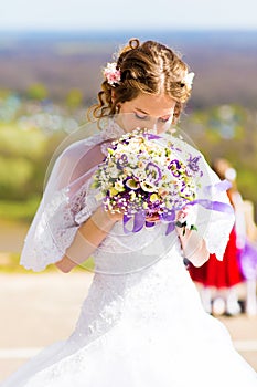 Beautiful wedding bouquet in hands of the bride