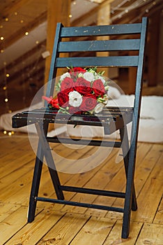 Beautiful wedding bouquet lying on a chair