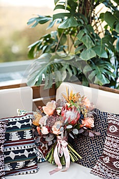 Beautiful wedding bouquet and pillows on the sofa