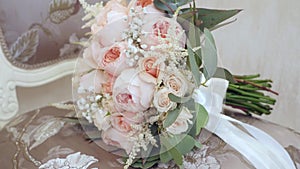 Beautiful wedding bouquet with pink flowers lying on the chair in the room