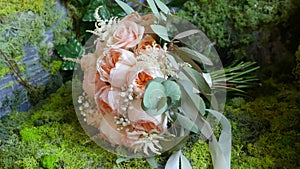 Beautiful wedding bouquet with pink flowers lying on the chair in the room