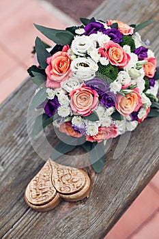 Beautiful wedding bouquet of white orange and pink roses with a decorative brown box for rings