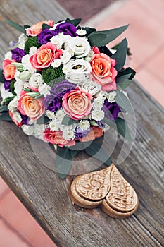 Beautiful wedding bouquet of white orange and pink roses with a decorative brown box for rings