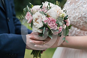 Beautiful wedding bouquet of white and pink peony in bride& x27;s.