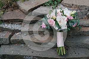 Beautiful wedding bouquet of white and pink peony and roses.