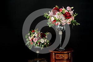 Beautiful wedding bouquets of the bride and girlfriend of the bride on a dark background