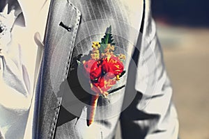 Beautiful wedding boutonniere at groom's costume