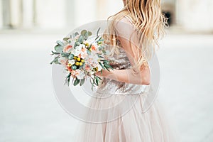 Beautiful wedding buoquet with roses in the hands