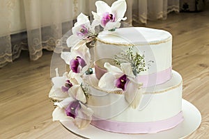 Beautiful wedding cake with flowers, close up of cake with blurr