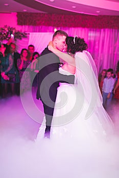 Beautiful wedding couple just married and dancing their first dance