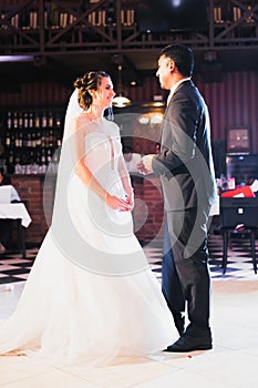 Beautiful wedding couple just married and dancing their first dance