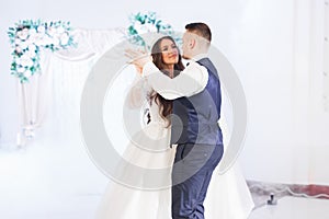 Beautiful wedding couple just married and dancing their first dance