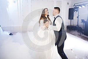 Beautiful wedding couple just married and dancing their first dance