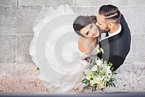 Beautiful wedding couple kissing in summer