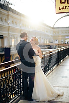 Beautiful wedding couple in Moscow, the bride and groom in a white dress in the interior, happy new family