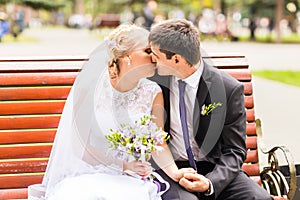 Beautiful wedding couple outdoors. They kiss and hug each other