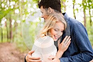 Beautiful wedding couple outside in green forest.