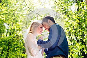 Beautiful wedding couple outside in green forest.