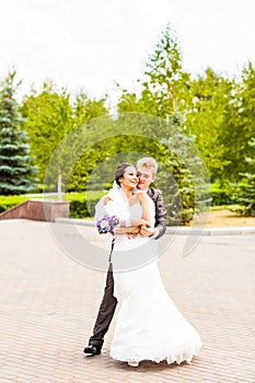 Beautiful wedding couple in park. kiss and hug