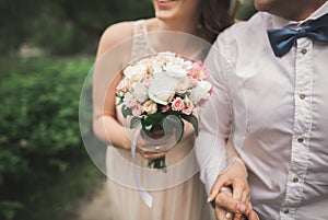 Beautiful wedding couple in park. kiss and hug each other