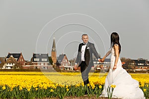 Beautiful wedding couple posing in field