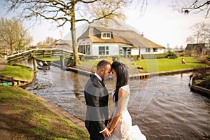 Beautiful wedding couple posing near river