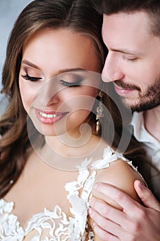 Beautiful wedding couple together. Bride and groom kiss and hug each other