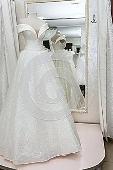 Beautiful wedding dress on a mannequin in salon
