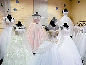 Beautiful wedding dresses on hangers in wedding atelier photo
