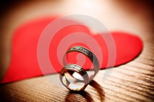 Beautiful wedding golden rings with a heart