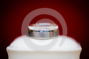 Beautiful wedding ring set on a white box and red background.