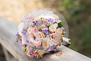 Beautiful wedding rings with bouquet of flowers. Declaration of love, spring.