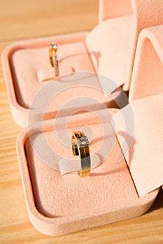 Beautiful wedding rings in box on wooden background