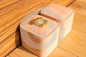 Beautiful wedding rings in box on wooden background