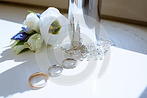 Beautiful wedding rings and perfume bottle for bride and groom