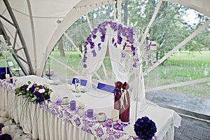 Beautiful wedding set decoration in the restaurant. Table of newlyweds outdoor tent