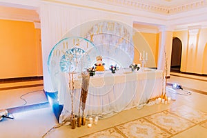 Beautiful wedding table decorated with flowers. Wedding cake. Sweets