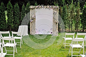 Beautiful wedding trellis decorated with flowers and congratulation on banner