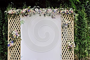 Beautiful wedding trellis decorated with flowers and congratulation on banner