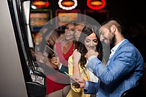 Group of People at Automat Machine in Casino photo