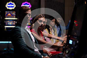 Group of People at Automat Machine in Casino