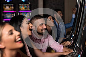 Young Group Playing Automat Machine in a Casino photo