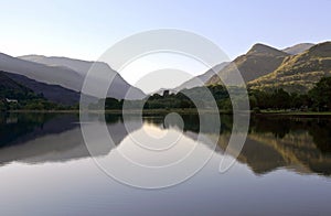 Beautiful Welsh Mountains reflected in a still waters of lake Llyn Padarn, Llan Beris Wales