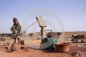 Beautiful West Africa Infant Working with Fresh Water for a dehydration concept photo