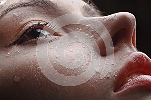 Beautiful wet female face with raindrops on it